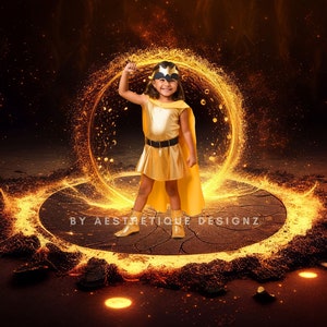 May include: A young child in a gold superhero costume with a cape and mask stands in front of a glowing golden portal. The image has a dark background with sparks and the text "BY AESTRETIQUE DESIGNZ".