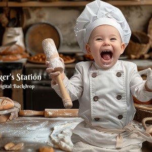 May include: A young baker wearing a white chef hat and uniform smiles while holding a wooden rolling pin covered in flour. The baker is surrounded by freshly baked bread and pastries in a rustic bakery setting. The text "Baker's Station Digital Backdrop" is visible in the image.