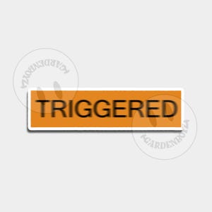 Peut inclure: Un autocollant rectangulaire avec le mot "TRIGGERED" en noir sur un fond orange. L'autocollant a une bordure blanche et est placé sur un fond gris clair.