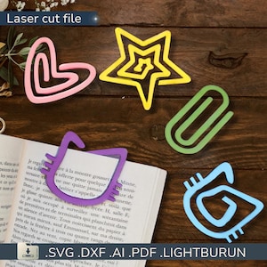 May include: A collection of laser-cut bookmarks in various shapes and colors, including a pink heart, yellow star, green paperclip, purple cat, and blue abstract design. The text "Laser cut file" is visible at the top. The bottom of the image shows the text ".SVG .DXF .AI .PDF .LIGHTBURUN".