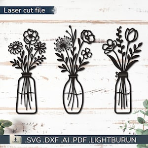 Pode incluir: Arte de parede preta cortada a laser com três vasos com arranjos florais. Cada vaso contém um buquê diferente de flores, incluindo margaridas, papoulas e tulipas. O texto "Laser cut file" está no topo.