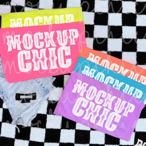 May include: A collection of colorful mockups, including pink, yellow, orange, blue, and purple, each displaying the text "MOCKUP CHIC" in a bold, white font. The items are arranged on a black and white checkered surface.