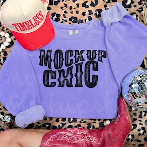 May include: A light purple sweatshirt with the text "MOCKUP CHIC" in black. A red and white baseball cap with the word "TIMELESS" is on the left. A pair of red cowboy boots and a disco ball are also in the image.
