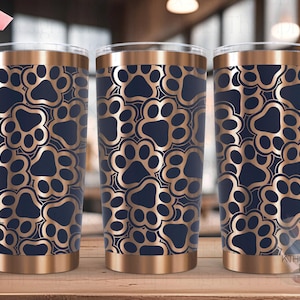 May include: Three stainless steel tumblers with a seamless copper and navy blue paw print pattern. The tumblers are ideal for holding beverages.