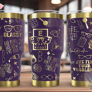 May include: Three purple and gold stainless steel tumblers with eye-themed designs. The tumblers feature gold text with phrases like "Keep It Glassy", "Bad Puns Are How Eye Roll", "Our Jokes Don't Get Any Cornea", and "Eye Fix Your Problems".