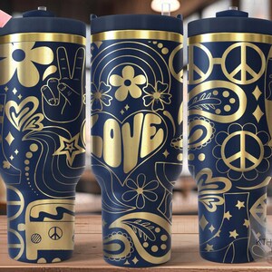 May include: A navy blue and gold stainless steel tumbler with a peace sign, flower, and love design. The tumbler has a lid and a handle.