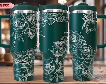 May include: A green stainless steel travel mug with a white floral design. The mug has a lid and a handle. The text "SEAMLESS" is visible in the top left corner of the image.