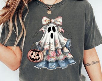 May include: Dark gray t-shirt featuring a whimsical ghost design with a floral bow and dress, holding a pumpkin basket. The ghost has three black eye holes. The text "MP ART STORE" is visible on the design. A fun Halloween-themed graphic.