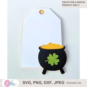 May include: A white tag with a gold-colored hole at the top, paired with a black pot of gold featuring a green shamrock. The pot is filled with yellow gold. Text on the image reads: "THIS IS FOR A DIGITAL PRODUCT ONLY!" and "SVG, PNG, DXF, JPEG Example Use".