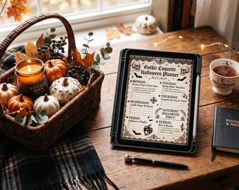 May include: A digital tablet displaying a Gothic Coquette Halloween Planner, a wicker basket filled with miniature pumpkins and a Witches Brew candle, a mug labeled Halloween Spirit, a black notebook titled Potions & Notes, and a skull-topped pen.
