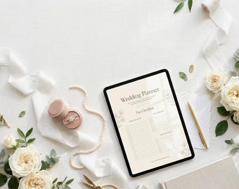 May include: A digital tablet displaying a Wedding Planner checklist, accompanied by a ring in a velvet box, a gold pen, white ribbon, and cream-colored roses. The screen text reads Wedding Planner and The Checklist.