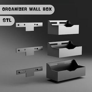 Könnte beinhalten: Ein Satz von drei schwarzen, wandmontierten Organizer-Boxen mit einer Metallhalterung zur Montage. Die Boxen sind übereinander gestapelt. Der Text "ORGANIZER WALL BOX" und "STL" ist im Bild sichtbar.