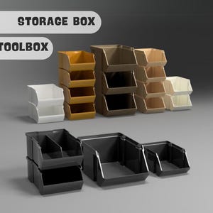 Puede incluir: Un conjunto de cajas de almacenamiento en varios colores, incluyendo negro, marrón y blanco. Las cajas están apiladas una encima de la otra y están etiquetadas como "STORAGE BOX" y "TOOLBOX".