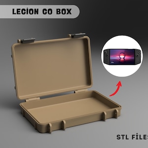 Puede incluir: Una caja beige abierta con cierres negros. El texto "LEGION GO BOX" está en la parte superior. Una imagen circular muestra una consola de juegos portátil negra. El texto "STL FILES" está en la parte inferior.