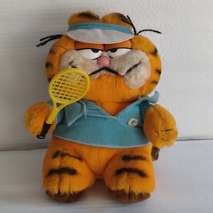 Gorgeous collectible and vintage stuffed Garfield, orange, playing tenis