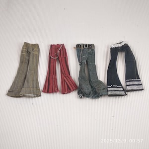 May include: Four pairs of doll-sized flared trousers in various styles. The trousers include brown patterned ones, red striped ones, distressed denim ones with a belt and chain, and black ones with white embellishments.