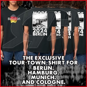 May include: Four black t-shirts with white text and graphics. The shirts feature the band "MODE" and the text "World Tour 2024 Berlin". The text "THE EXCLUSIVE TOUR TOWN SHIRT FOR BERLIN. HAMBURG. MUNICH. AND COLOGNE." is printed below the shirts.