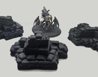 May include: Miniature black terrain pieces for tabletop gaming. The set includes sandbag barricades and a detailed model of a mechanical creature with a rider. Ideal for war games and miniature wargaming.