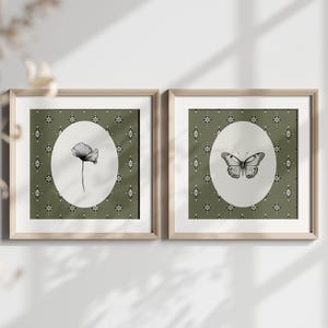 May include: Two framed prints with a green background and white oval frames. The left print features a black and white illustration of a flower. The right print features a black and white illustration of a butterfly.