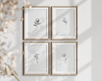 May include: Four framed botanical prints featuring delicate grayscale floral illustrations. Each print showcases a different flower, including a peony, a sprig of small blossoms, and a single-petal flower. The frames are a light wood color.