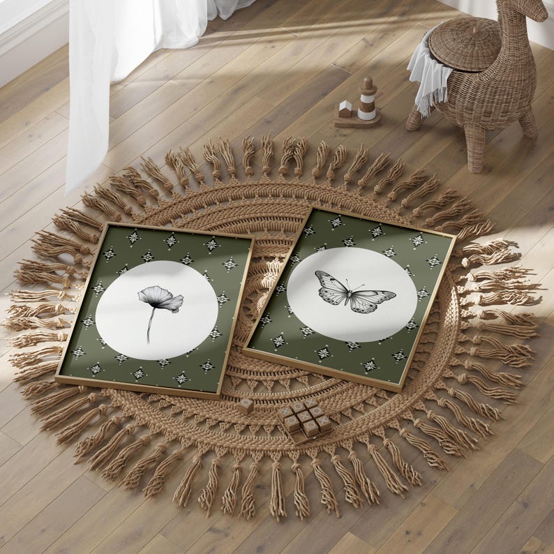 May include: Two framed prints with a green background and white circles. One print features a black and white illustration of a butterfly, and the other print features a black and white illustration of a flower. The prints are on a round, woven rug with fringe.