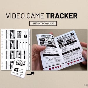 May include: A white and black video game tracker with the text "VIDEO GAME TRACKER" and "INSTANT DOWNLOAD". The tracker is open, showing game details, and has a small booklet version next to it. The booklet says "POCKET GAMES".
