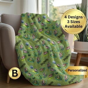May include: A green fleece throw blanket with a repeating pattern of frogs sitting on lily pads. The blanket is personalized with the name "Benjamin" in black text.