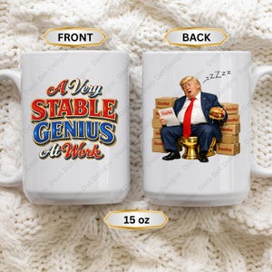 May include: A white 15 oz ceramic mug featuring the text A Very Stable Genius At Work on the front. The back displays an illustration of a man in a suit and red tie sitting on a gold toilet surrounded by boxes labeled Classified, holding a burger.
