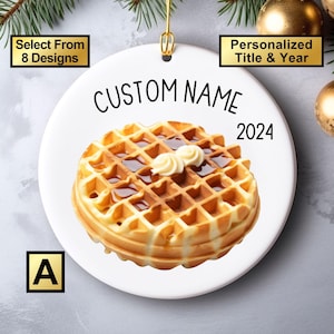 May include: White ceramic Christmas ornament with a waffle, butter, and syrup design. The ornament is personalized with the text "CUSTOM NAME" and the year "2024".