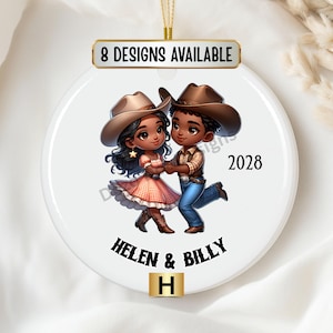May include: A white ceramic ornament with a cartoon illustration of a couple in cowboy hats dancing. The text "Helen & Billy" and the year "2028" are printed on the ornament. The ornament also has the text "8 Designs Available" and the letter "H" printed on it.