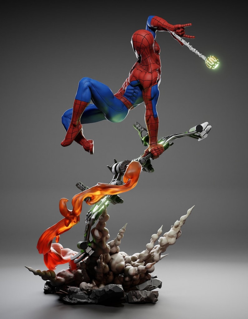 May include: A dynamic figurine of Spider-Man in a red and blue suit, mid-air, grasping a weapon. The base features a Green Goblin glider with orange and green energy effects, and a smoky, rocky base. The overall theme is action and superhero.