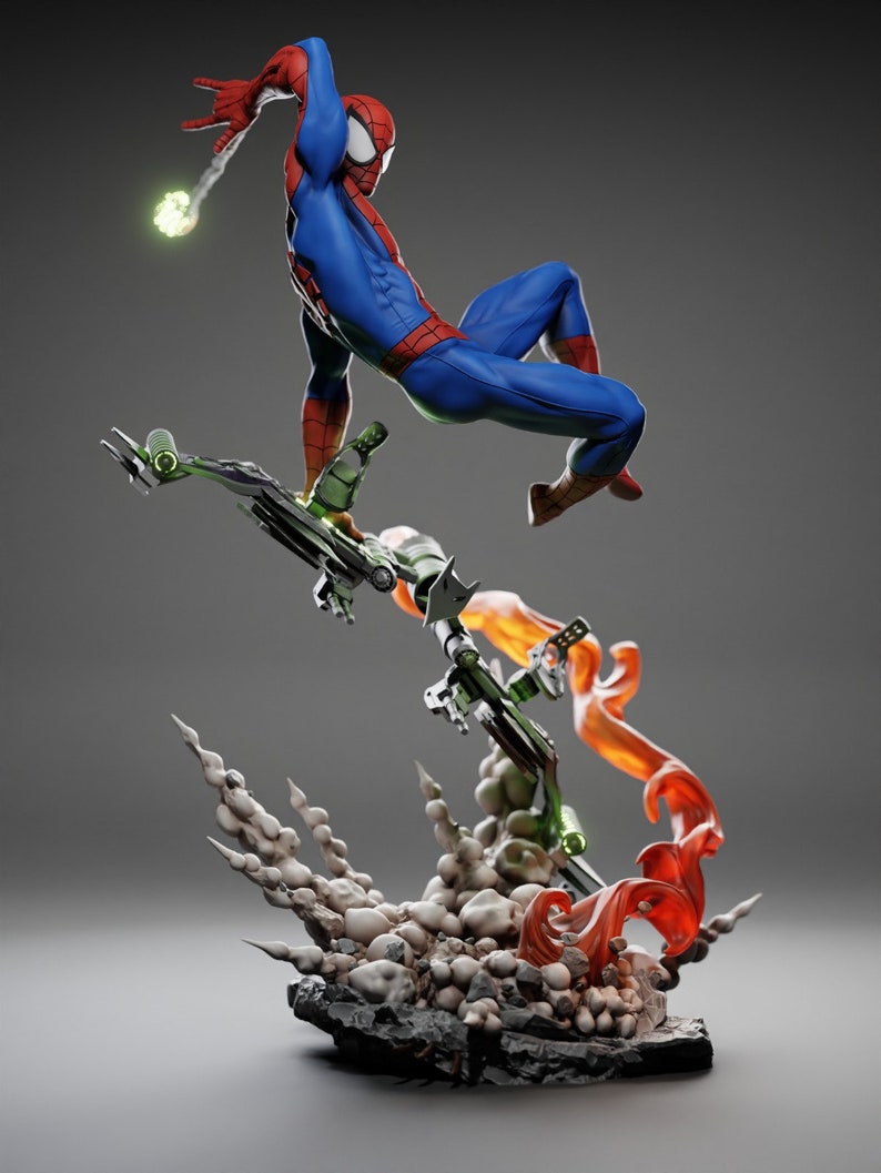 May include: A dynamic figurine of Spider-Man in a classic blue and red suit, leaping into action. He is battling the Green Goblin, who is riding a green glider with orange flames and smoke effects. The base is a rocky terrain.