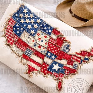 May include: A cushion with a patchwork design in the shape of the United States. The cushion features a patriotic colour scheme with red, white, and blue fabrics, including stars and stripes. A straw cowboy hat is nearby.