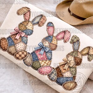 Puede incluir: Tres diseños de conejos de patchwork con coloridos patrones de tela y lazos. Los conejos están dispuestos sobre una superficie blanca, con un sombrero de tonos neutros en el fondo. Los conejos tienen una estética rústica y hecha a mano.