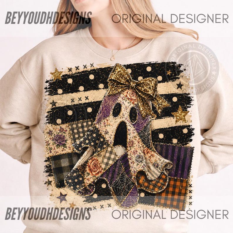 May include: A beige crewneck sweatshirt featuring a graphic of a ghost adorned with a large gold glitter bow. The ghost is layered over a patchwork background of black and beige stripes, polka dots, spiderwebs, and floral patterns with gold stars.