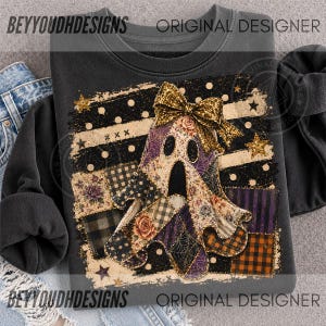 May include: A dark grey sweatshirt featuring a central graphic of a ghost adorned with a large gold glitter bow. The ghost is composed of various patchwork patterns including floral prints, black and orange plaid, purple stripes, and spider webs.