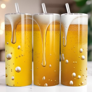 May include: Three stainless steel tumblers with lids and straws. The tumblers are filled with a yellow liquid that looks like beer. The liquid has a white foamy head and drips down the sides of the tumblers.