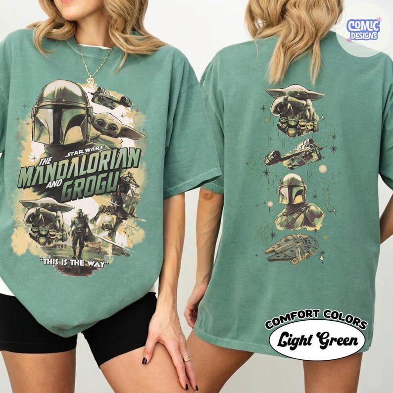 May include: Light green t-shirt featuring Star Wars characters The Mandalorian and Grogu. The front graphic includes the Mandalorian's helmet, Grogu, and the text "THIS IS THE WAY." The back displays additional Star Wars imagery.