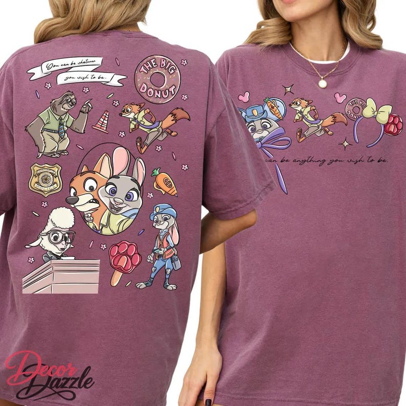 May include: A maroon t-shirt featuring cartoon characters from Zootopia. The design includes Judy Hopps, Nick Wilde, and other characters, along with the text "You can be anything you wish to be" and "The Big Donut".