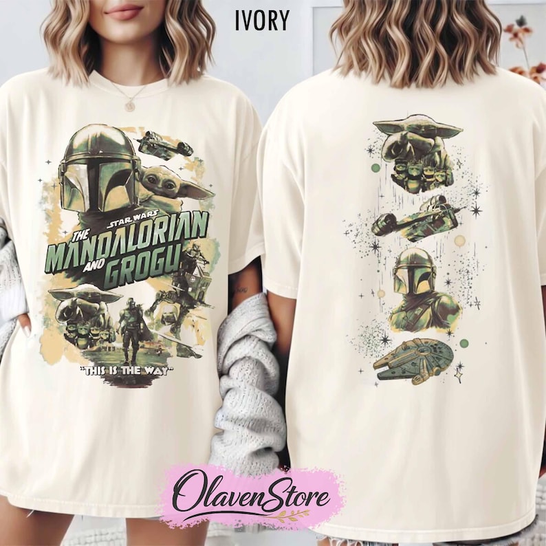 May include: Ivory-colored t-shirt featuring a graphic design from the Star Wars series, "The Mandalorian and Grogu." The front displays characters and text, while the back showcases additional imagery. The shirt has a relaxed fit.