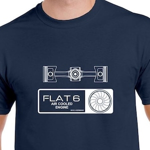 May include: A navy blue t-shirt with a white graphic of a flat-six air-cooled engine. The graphic includes the text "FLAT 6 AIR COOLED ENGINE".