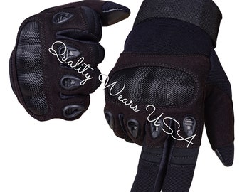 May include: A pair of black tactical gloves featuring reinforced knuckle protection, mesh fabric panels, and adjustable wrist straps. The text Quality Wears USA is printed across the surface of the gloves, which are designed with textured grip areas on the fingers and palms.