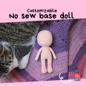 May include: A crocheted, no-sew base doll in a light peach color, with a rounded head and simple limbs. The doll is displayed on a purple and pink crocheted blanket. Text on the image reads "Customizable No sew base doll". A cat is in the background.