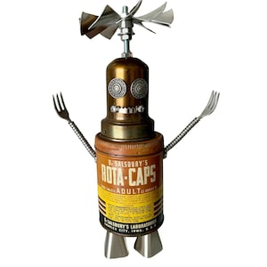 May include: A quirky robot sculpture constructed from recycled metal components. It has a propeller head, fork arms, and a body made from a vintage "ROTA-CAPS" tin. This is a unique piece of industrial art, with a height of approximately 20 cm.