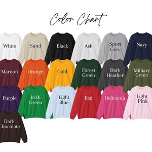 May include: Color chart showing 18 different sweatshirt colors. The colors include white, sand, black, ash, sport grey, navy, maroon, orange, gold, forest green, dark heather, military green, purple, irish green, light blue, red, heliconia, and light pink.