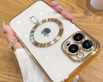 May include: White iPhone case with a gold trim and a gold ring around the camera lens. The case has a clear back and a gold ring around the camera lens. The case also has a gold ring around the Apple logo. "With Lens Protector" is written in the top right corner of the image.