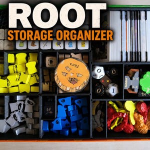 May include: A black board game storage organiser box containing various game components including yellow, blue, and grey wooden tokens, white dice, card decks, and a circular wooden token with the text Nora printed on the surface.
