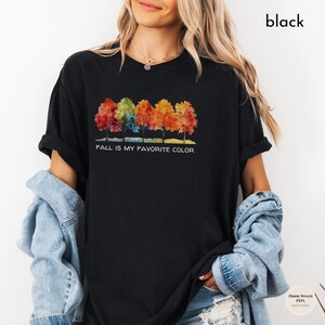 May include: Black t-shirt with a watercolor design of five colorful trees and the text "Fall is my favorite color".
