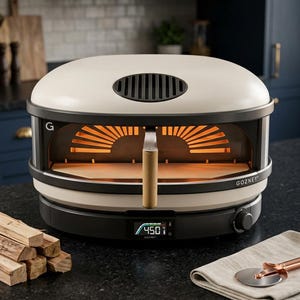 May include: Cream and black outdoor pizza oven with a wooden handle and digital temperature display showing 450 degrees Fahrenheit. The oven has a black base and a cream-colored top with the brand name "Gozney".