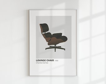 May include: Framed print of a mid-century modern lounge chair. The chair has a black headrest and seat with a brown wooden frame. The print includes the text "LOUNGE CHAIR 1956 Charles Eames."